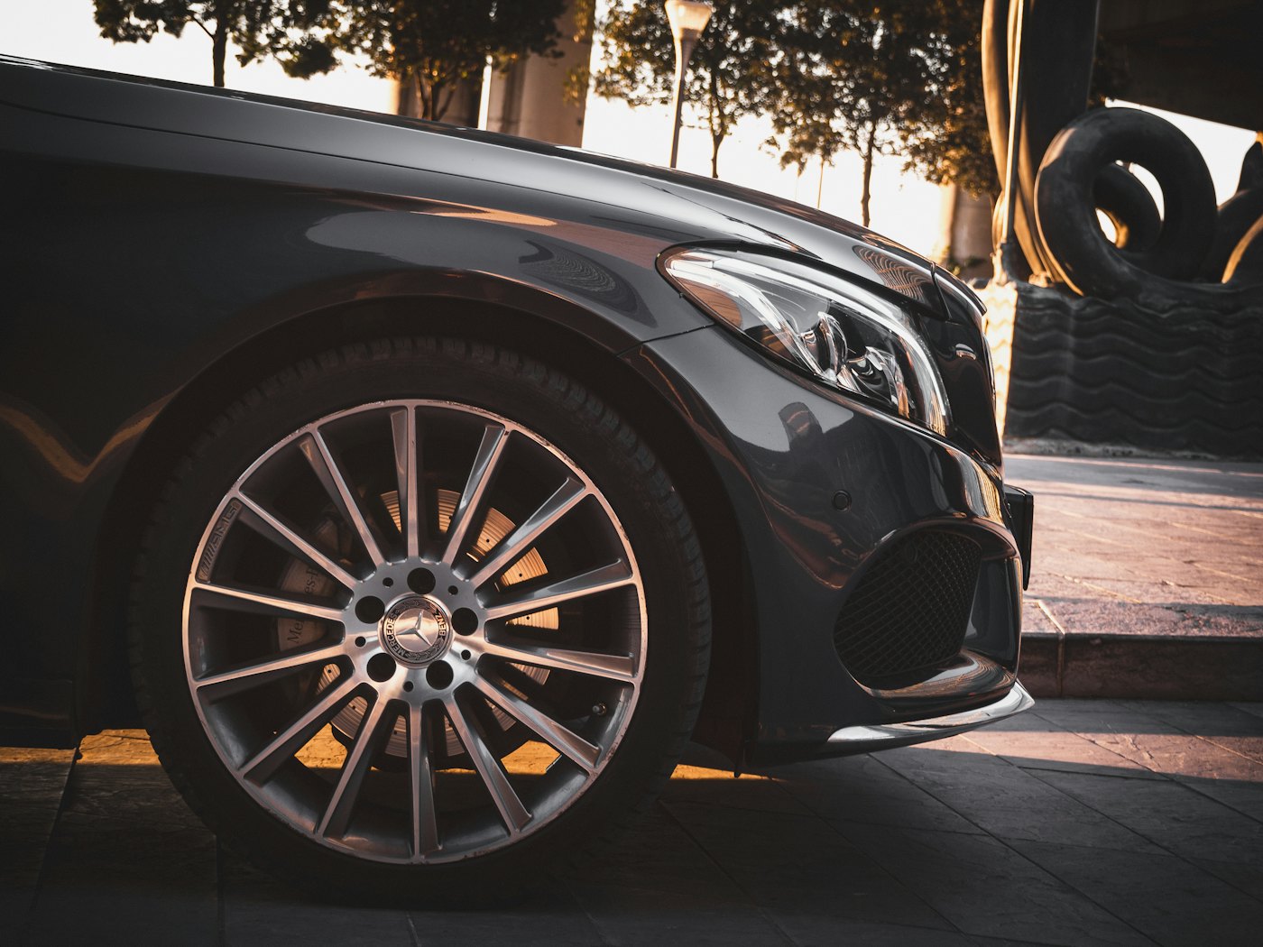 A black executive car parked in the city