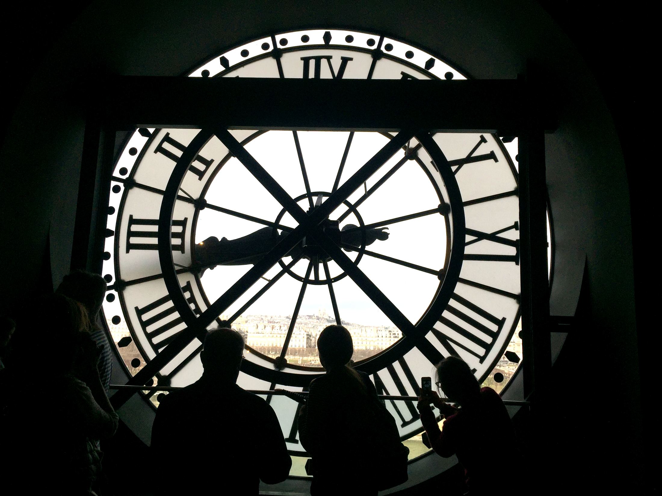 Silhouettes at the great clock window of the Musée d'Orsay, Paris