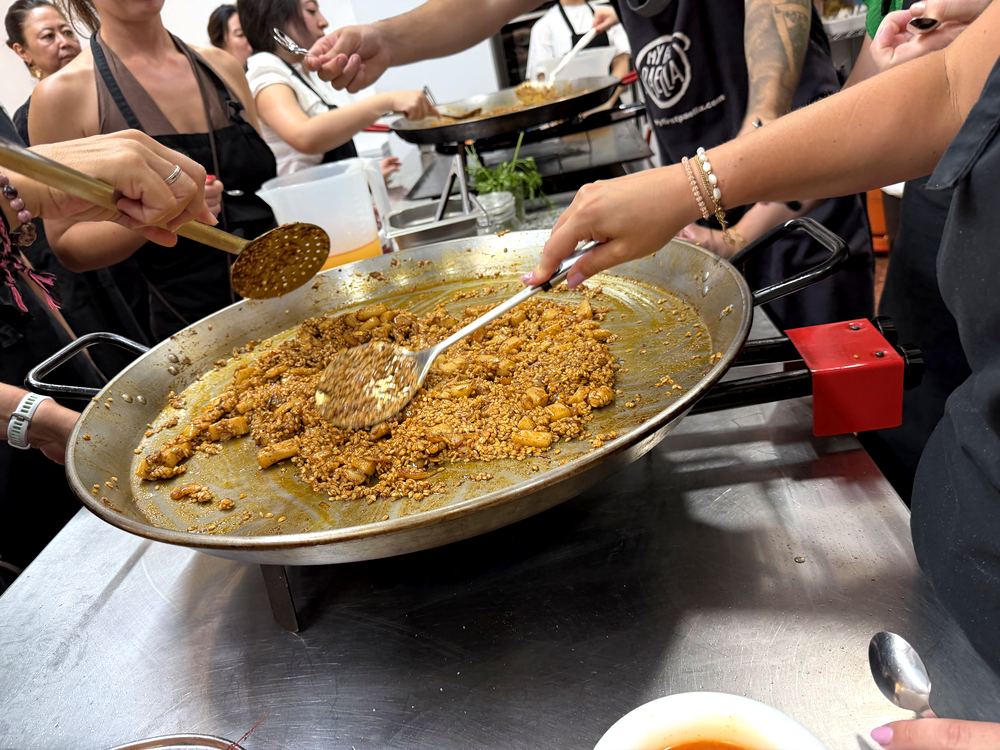 Students cooking paella with a chef in Valencia