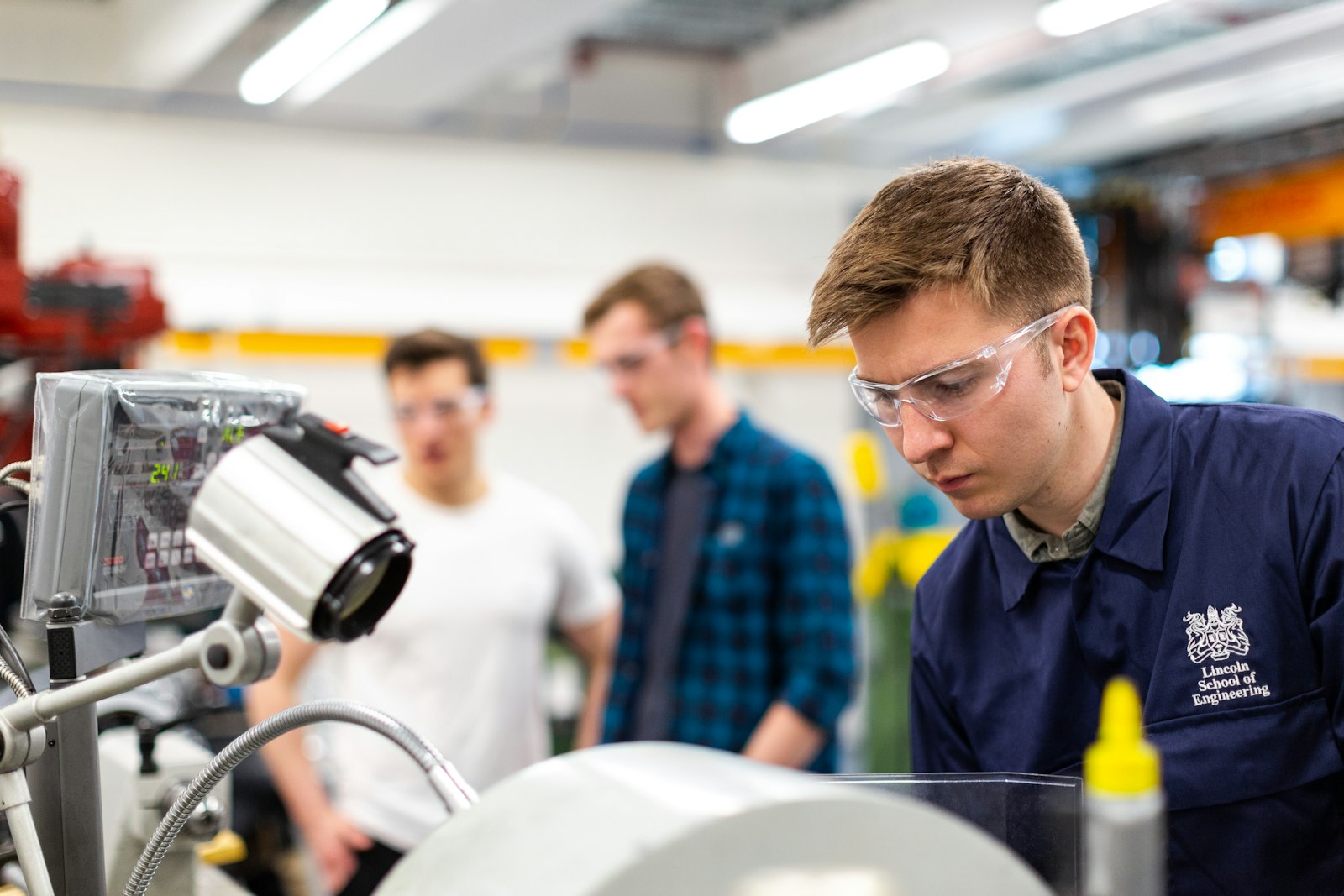 Young people with safety glasses in an engineering laboratory